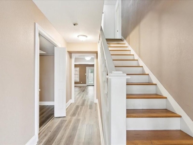 stairs featuring hardwood / wood-style flooring