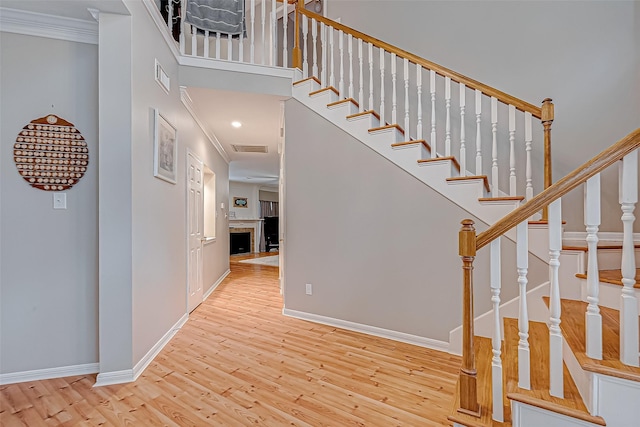 interior space with ornamental molding and light hardwood / wood-style floors