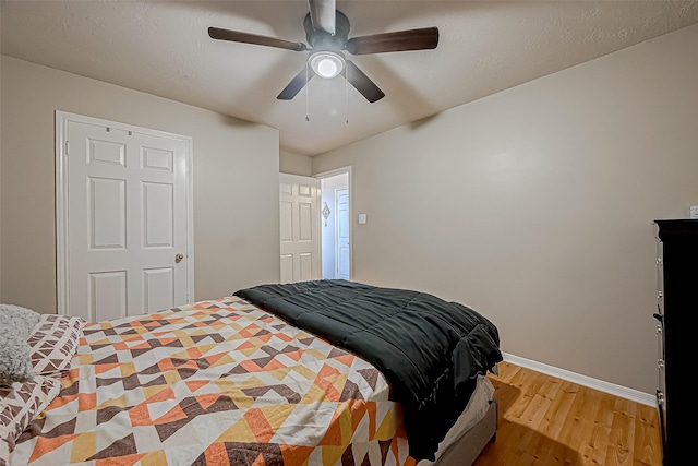 bedroom featuring hardwood / wood-style flooring and ceiling fan