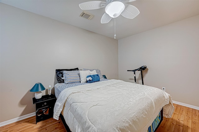 bedroom with ceiling fan and wood-type flooring