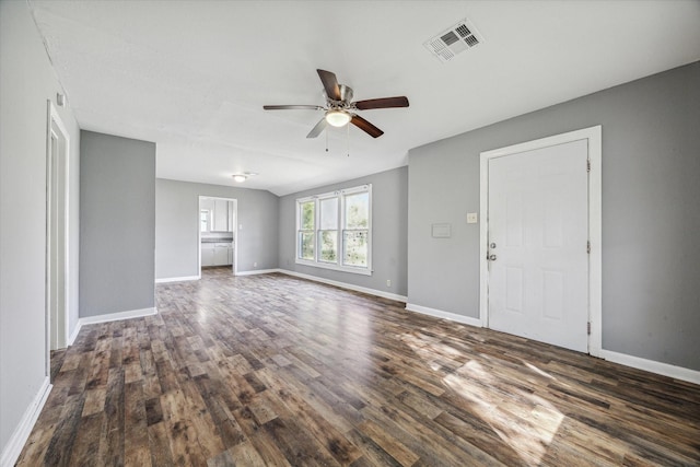 unfurnished living room featuring dark wood-type flooring and ceiling fan