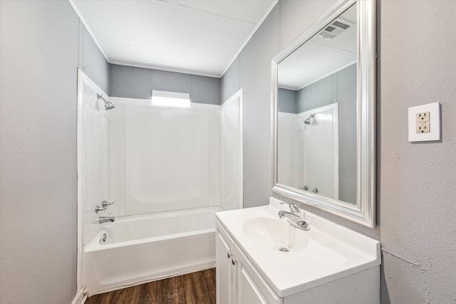 bathroom with vanity, hardwood / wood-style flooring, and bathing tub / shower combination