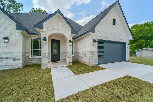 view of front of home with a garage and a front lawn