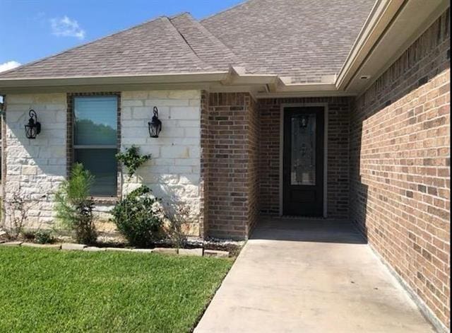 doorway to property with a yard