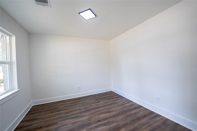 spare room featuring dark hardwood / wood-style flooring