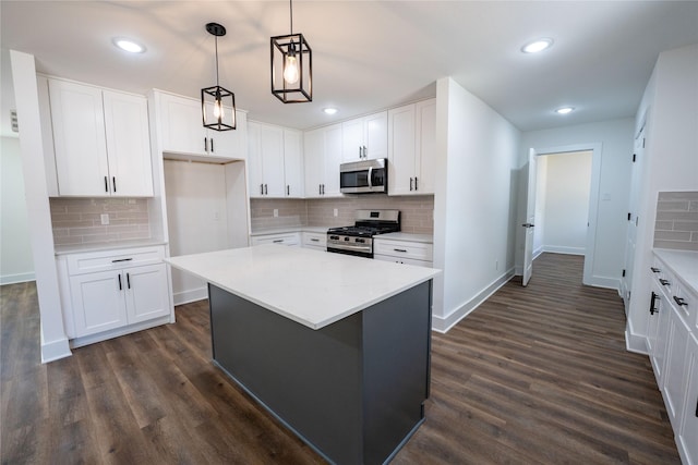 kitchen featuring white cabinetry, stainless steel appliances, and a center island