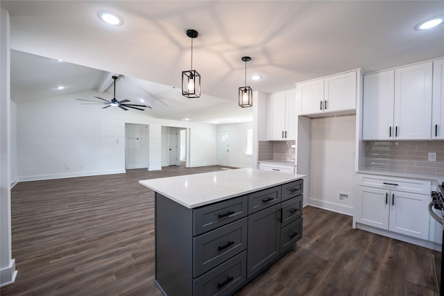 kitchen with pendant lighting, dark wood-type flooring, decorative backsplash, and white cabinets