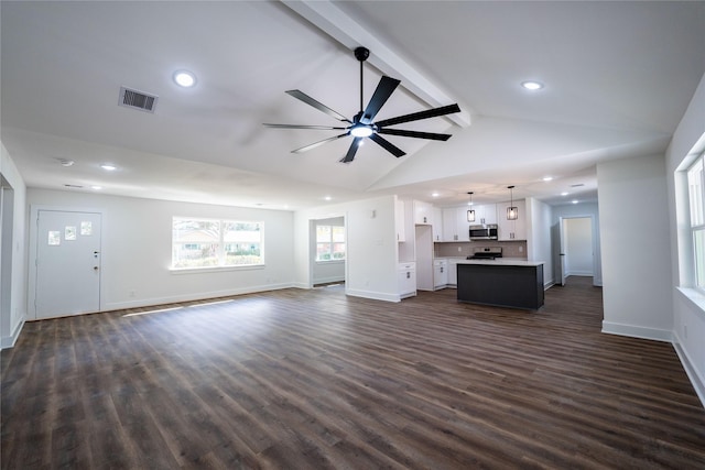 unfurnished living room featuring dark wood-type flooring, ceiling fan, and vaulted ceiling with beams