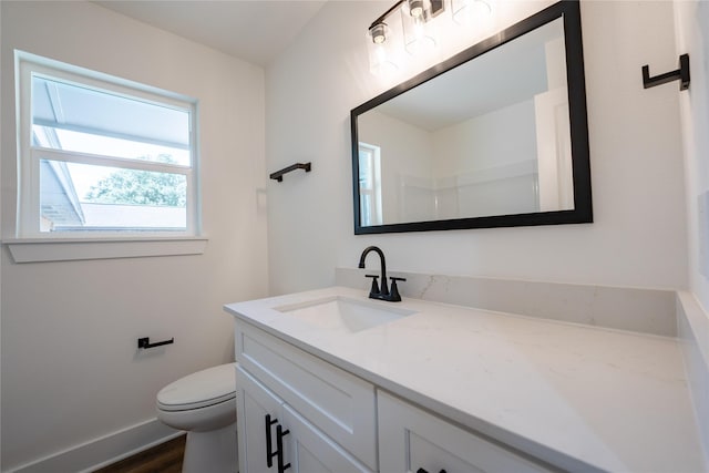 bathroom featuring vanity, hardwood / wood-style flooring, and toilet