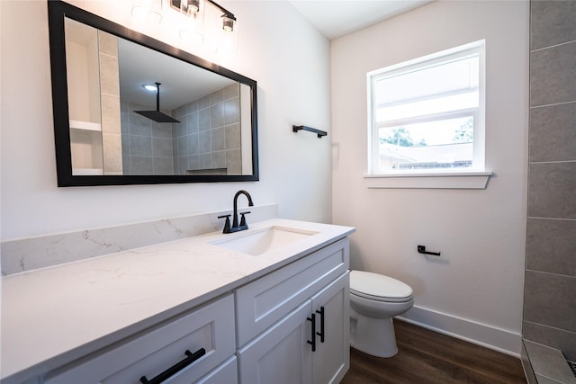 bathroom with vanity, wood-type flooring, toilet, and walk in shower