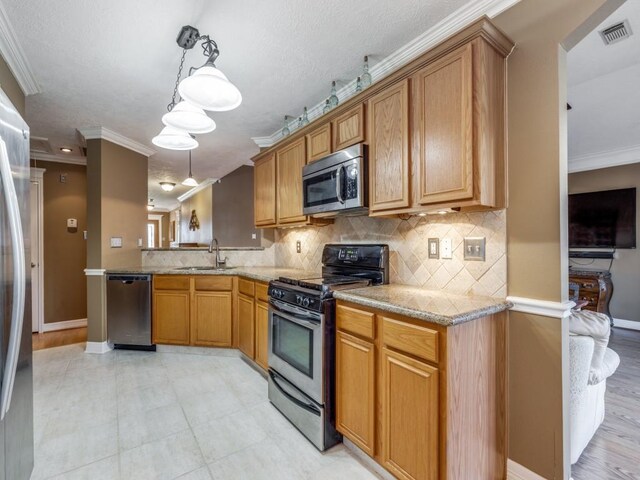 kitchen with pendant lighting, tasteful backsplash, sink, stainless steel appliances, and crown molding