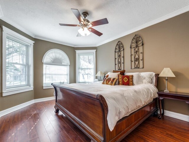 bedroom with ceiling fan, ornamental molding, dark hardwood / wood-style floors, and a textured ceiling