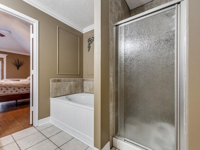 bathroom featuring ornamental molding, shower with separate bathtub, tile patterned flooring, and a textured ceiling