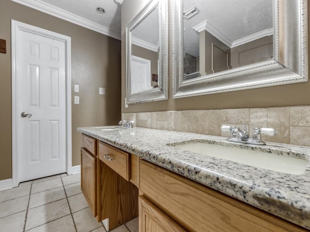 bathroom featuring vanity, crown molding, tile patterned floors, and a textured ceiling