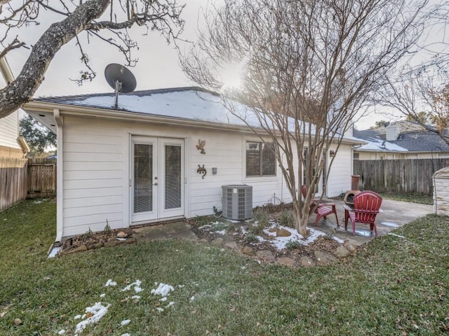 back of house featuring cooling unit, a patio, a lawn, and french doors