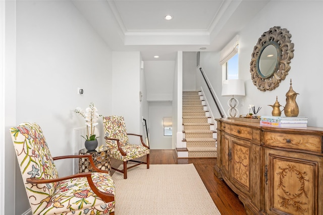 sitting room featuring crown molding, dark hardwood / wood-style flooring, and a tray ceiling