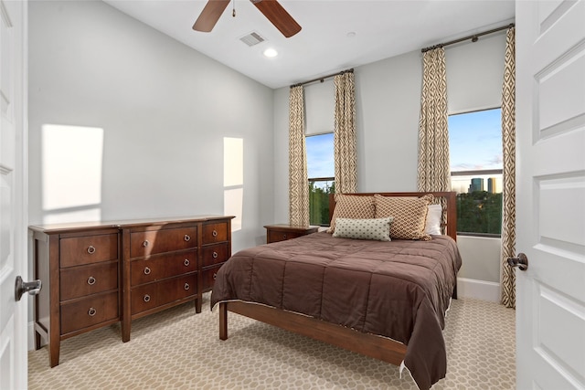 bedroom featuring light carpet and ceiling fan