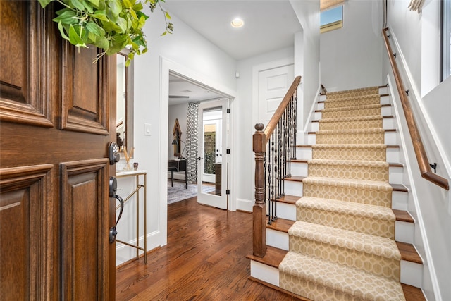 entryway with dark hardwood / wood-style flooring