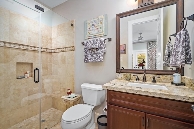 bathroom with vanity, an enclosed shower, and toilet