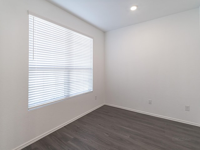 spare room featuring dark hardwood / wood-style flooring