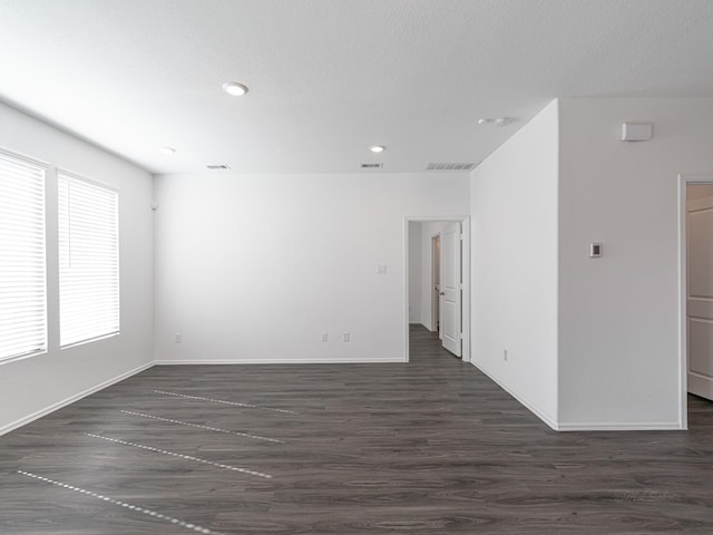 empty room featuring dark hardwood / wood-style flooring