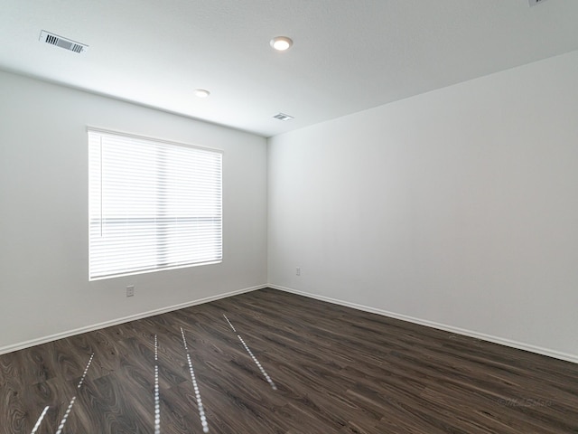 unfurnished room featuring dark wood-type flooring