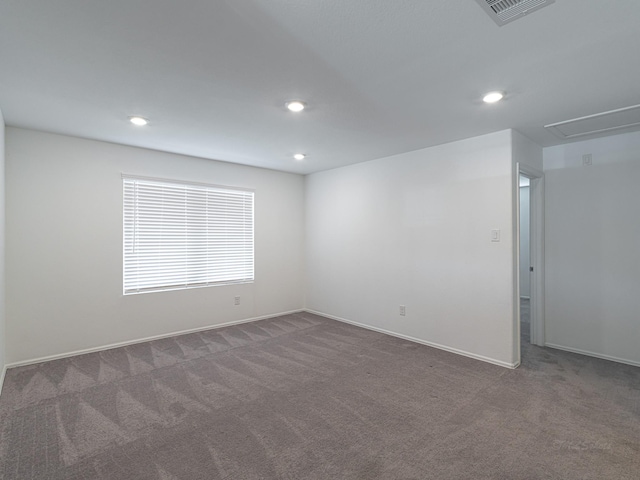 unfurnished room featuring dark carpet