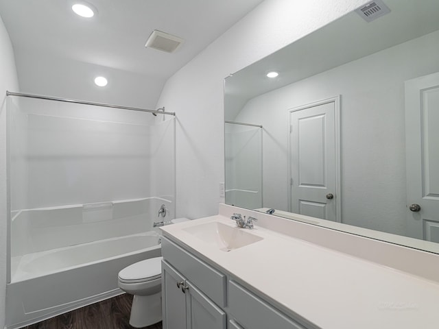 full bathroom with vaulted ceiling, wood-type flooring, bathtub / shower combination, vanity, and toilet