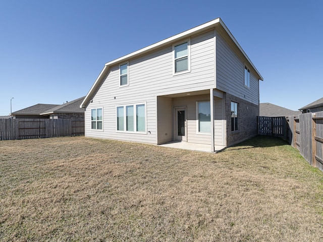 back of house with a yard and a patio area