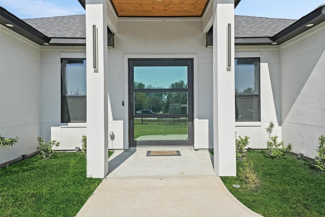 doorway to property with a yard