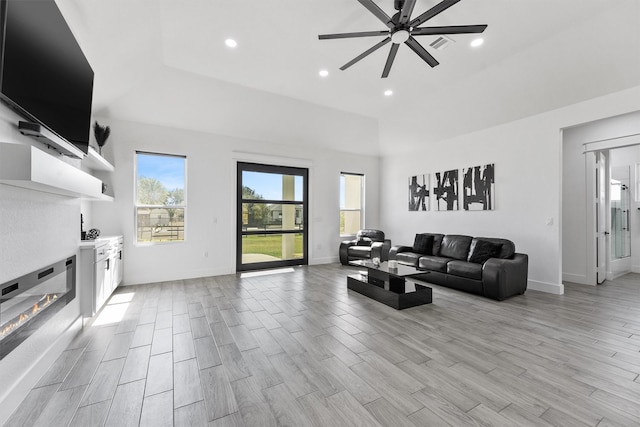 living room with ceiling fan and plenty of natural light