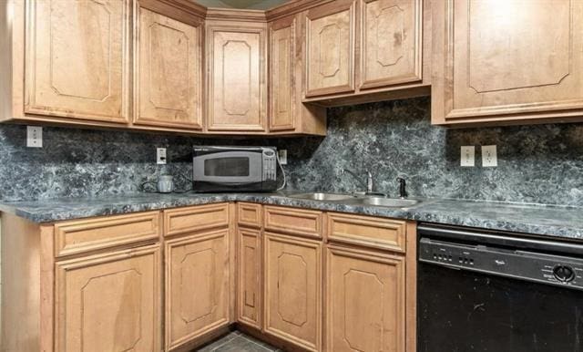 kitchen with black dishwasher, sink, and backsplash