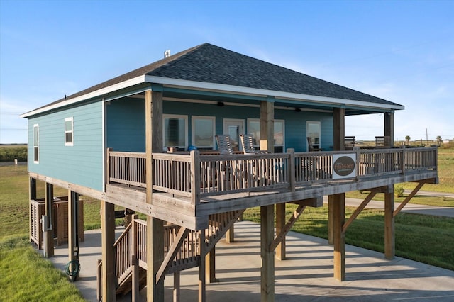 rear view of property featuring ceiling fan