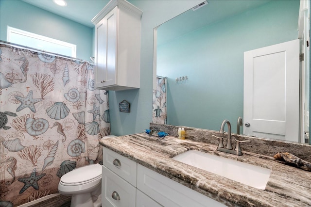 bathroom featuring vanity and toilet