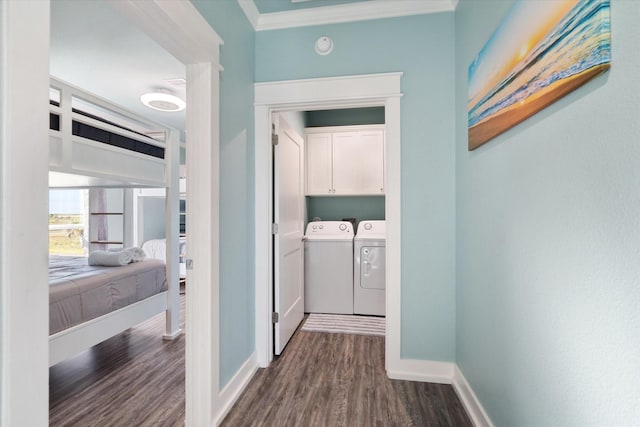 corridor featuring separate washer and dryer, crown molding, and dark hardwood / wood-style flooring