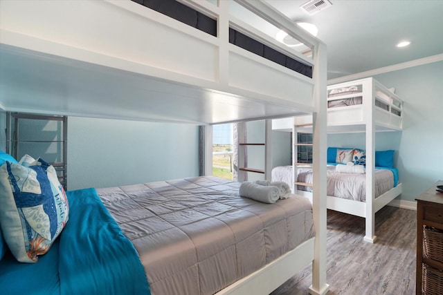 bedroom featuring hardwood / wood-style flooring and ornamental molding