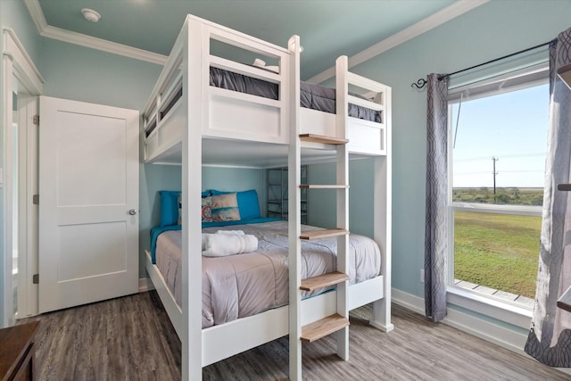 bedroom featuring crown molding and wood-type flooring