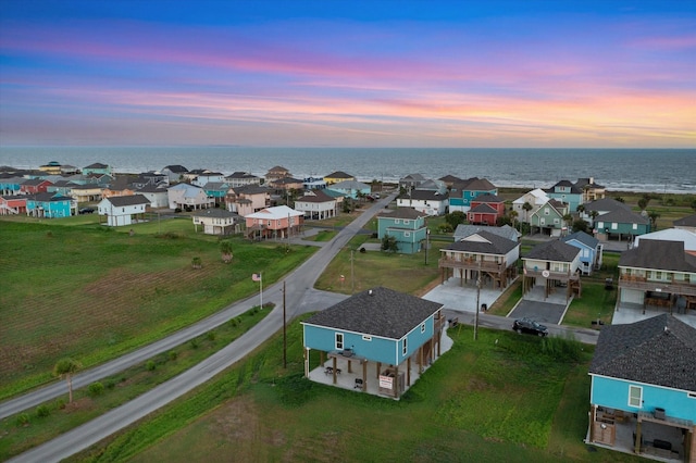 aerial view at dusk with a water view