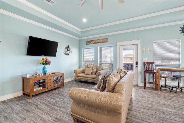 living room featuring crown molding, wood-type flooring, and ceiling fan