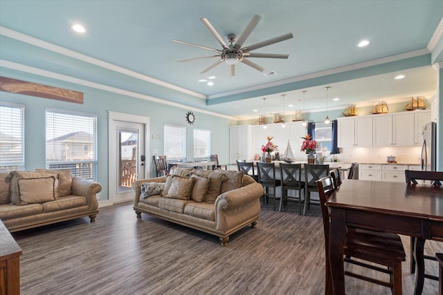 living room with dark wood-type flooring, ornamental molding, and a wealth of natural light