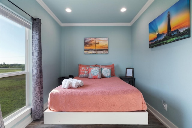 bedroom with multiple windows, wood-type flooring, and crown molding