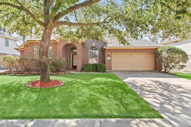 view of front of house featuring a garage and a front lawn