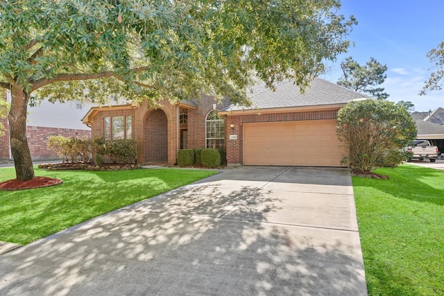 view of front of home with a garage and a front yard