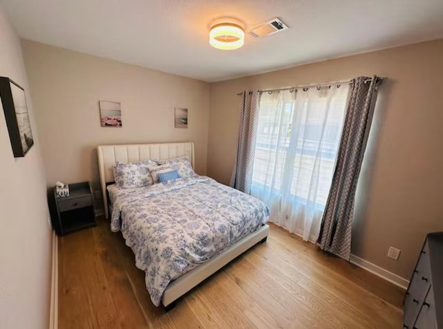 bedroom with hardwood / wood-style floors