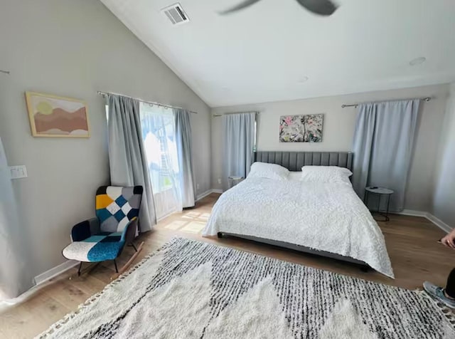 bedroom featuring vaulted ceiling, hardwood / wood-style floors, and ceiling fan