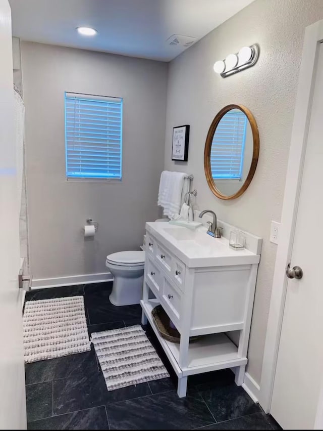 bathroom featuring tile patterned floors, vanity, and toilet