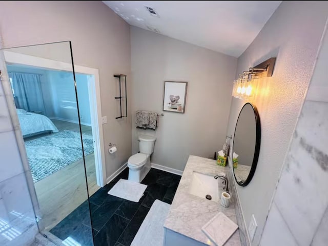 bathroom featuring tile patterned floors, vanity, and toilet