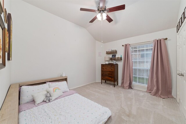 bedroom featuring lofted ceiling, light colored carpet, and ceiling fan