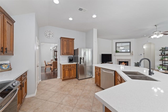 kitchen featuring sink, light tile patterned floors, ceiling fan, appliances with stainless steel finishes, and tasteful backsplash