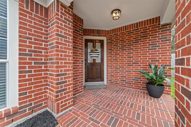 view of exterior entry featuring covered porch